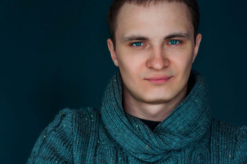 Portrait of an attractive young man in a warm sweater