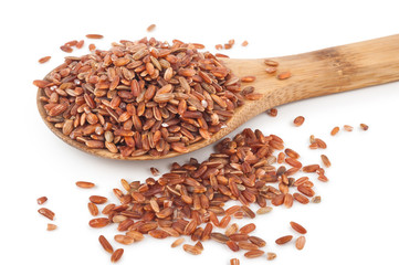 Red rice in a wooden spoon