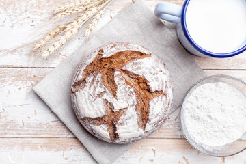 Delicious fresh bread on wooden background