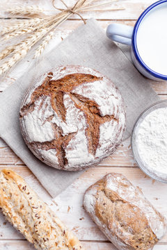 Delicious fresh bread on wooden background