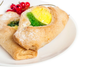 Bake isolated. Scones with jam on a plate. Pastry sprinkled with chocolate. Red currant.