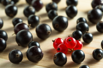 border of fresh berries mix on wooden tabletop