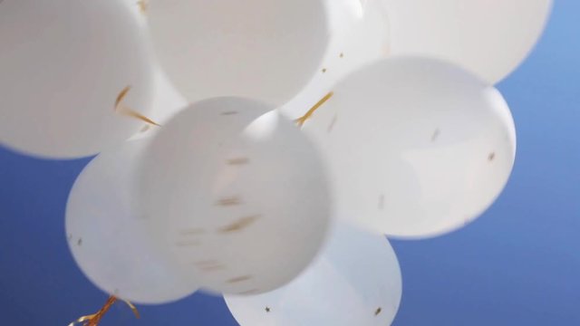inflated white helium balloons in blue sky 6