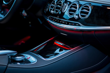 Luxury car interior details. Middle console with air and climate controls