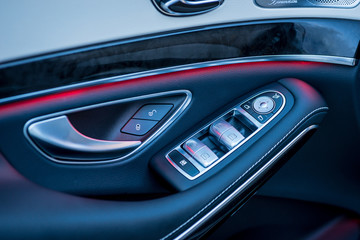 Luxury car interior. Door, seat and window controls