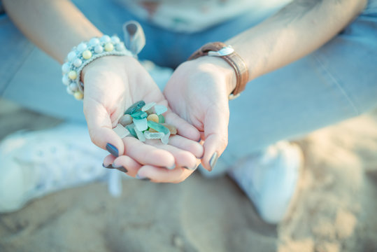 Sea glass pieces in the hands of a woman