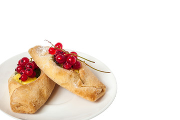Bake isolated. Scones with jam on a plate. Pastry sprinkled with chocolate. Red currant.