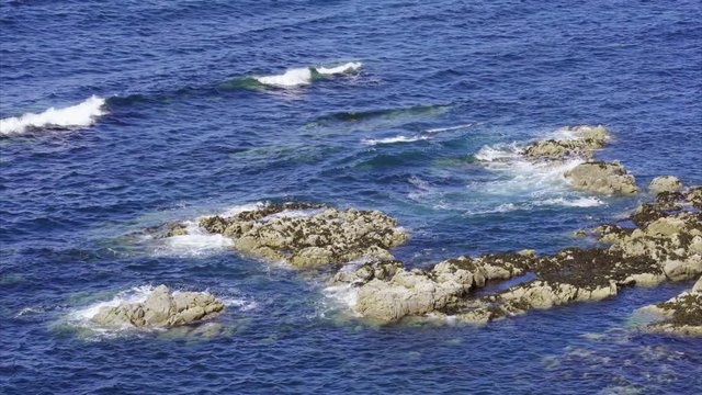 Waves breaking over rocks on the coast near Neist Point Macleod's Maidens on the Isle of Skye, Scotland, UK.