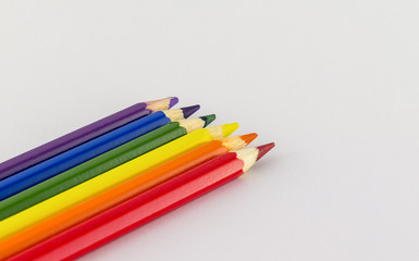 Frame of six multicolored pensils isolated on white background