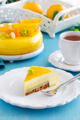 Cake with orange mousse and almond krokantom in the mirror glaze. Selective focus.