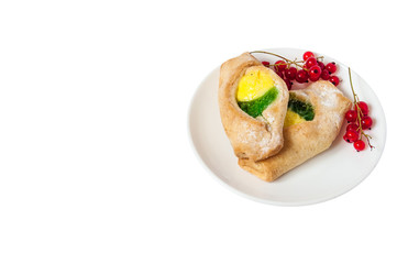 Bake isolated. Scones with jam on a plate. Pastry sprinkled with chocolate. Red currant.