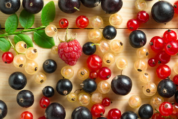 border of fresh berries mix on wooden tabletop