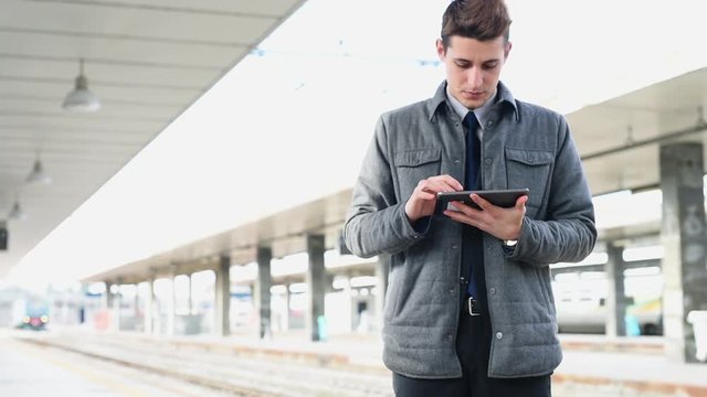 Using digital tablet at railroad platform