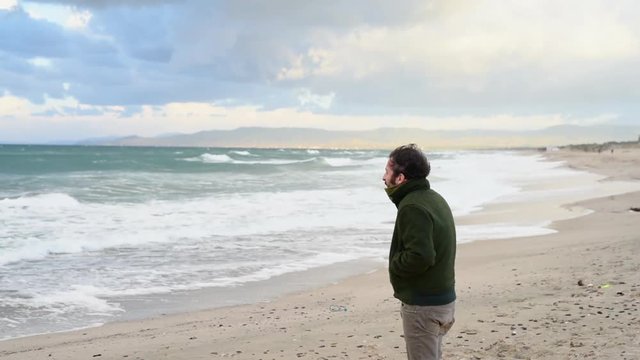 Standing on sandy beach