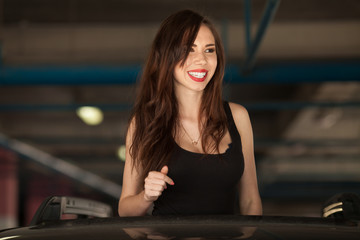 Young beautiful woman smoking ( vaping ) e-cigarette with smoke in car luke