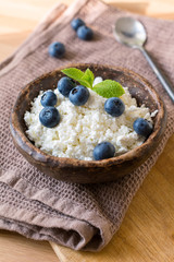 Cottage cheese (quark) with fresh blueberries decorated with mint. Healthy country breakfast