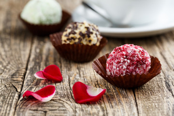 Delicious vegetarian truffle candies on wodden table.