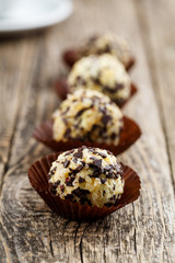 Delicious vegetarian truffle candies on wodden table.