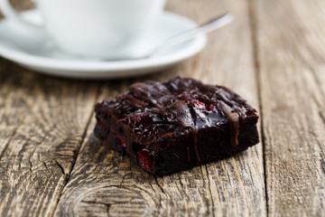 Tasty vegetarian brownie slice on wooden table for celebration.