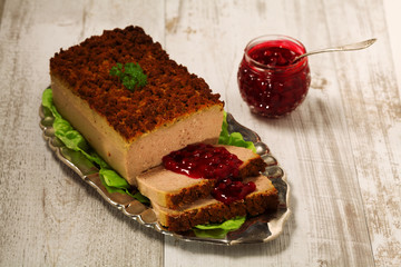 Homemade meat pie with vegetables, served with cranberry sauce