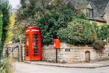 Delightful corner of a typical limestone house in the center of the village. Red booth and mailbox