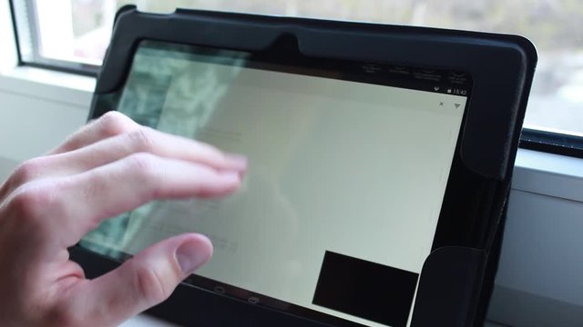 Somebody is searching youtube on a tablet