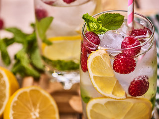 Wooden boards glasses with alcohol cocktail and ice cubes. Drink number hundred seventy five close up of cocktail raspberry mohito with straw . Country life.