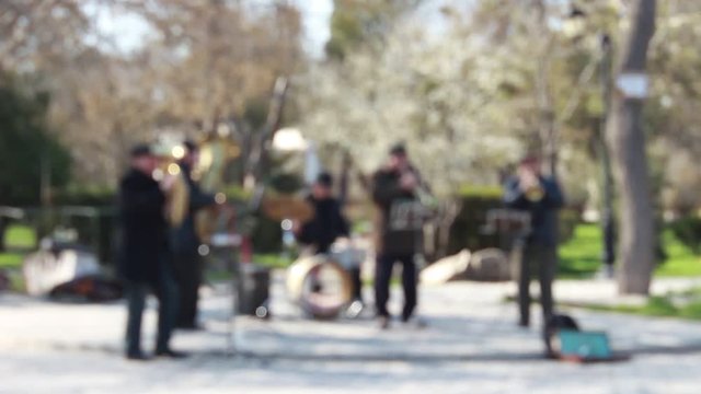 Anonymous musicians play in a park
