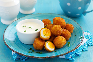 Quail eggs, deep fried with white sauce.