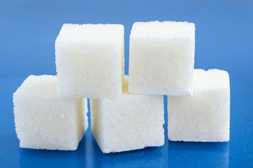 Sugar cubes on blue