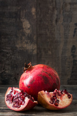 Pomegranate on rustic wooden background

