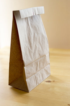 Brown paper bag on wood table
