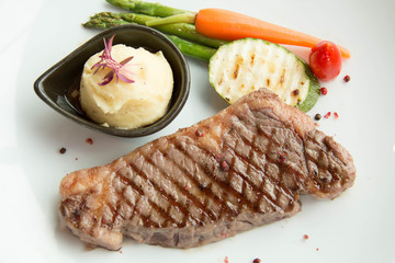 beef steak with  asparagus, and red carrot garnish.