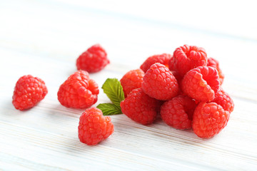 Red raspberries on a white wooden table