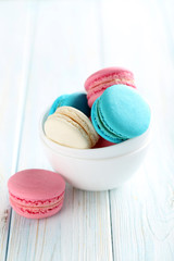 Tasty french macarons on a blue wooden table