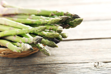 Fresh green asparagus on a grey wooden table