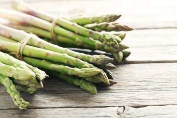 Fresh green asparagus on a grey wooden table