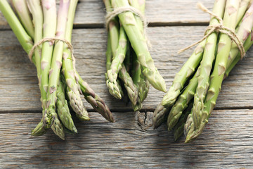 Fresh green asparagus on a grey wooden table