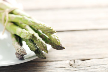 Fresh green asparagus on a grey wooden table