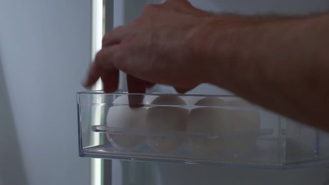 Taking eggs from a fridge