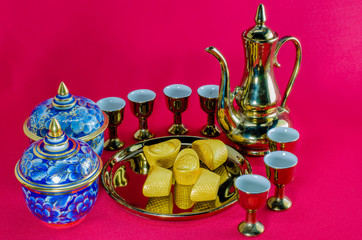 Obraz na płótnie Canvas Gold ingot Gold jug Tea glass benjarong on red background.