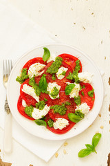 Delicious salad of tomato, mozzarella and pesto.