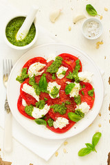 Delicious salad of tomato, mozzarella and pesto.