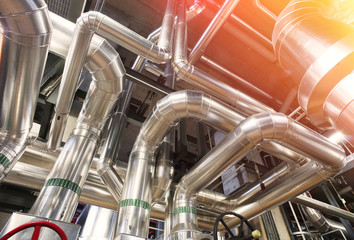 Equipment, cables and piping as found inside of a modern industr