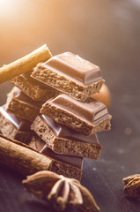 Two chocolate buildings on a dark background. energy and sugar. Broken bar. Chocolate blocks stack 