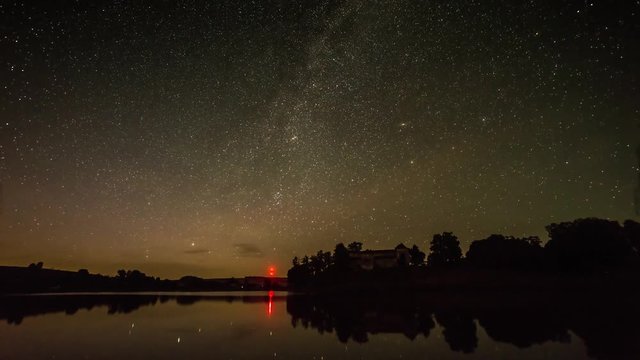 Night startrail in front of old castle and lake