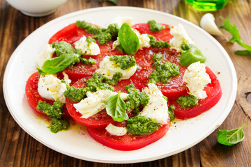 Delicious salad of tomato, mozzarella and pesto.