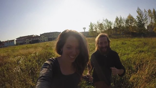 Couple running in meadow