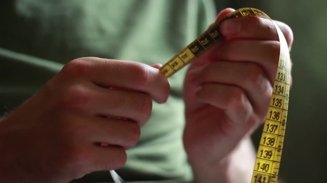 Man with tape centimeter