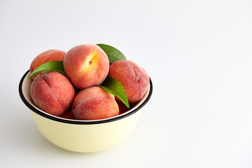 Fototapeta na wymiar Ripe peaches in bowl isolated on white
